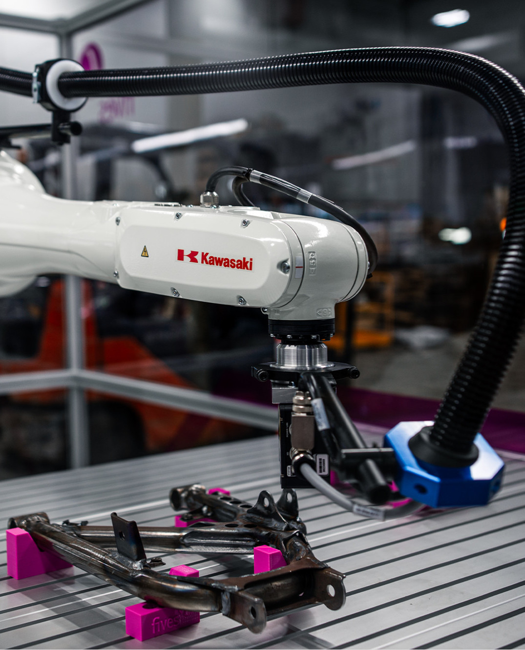 Automated robotic weld inspection arm scanning a complex welded assembly in real time